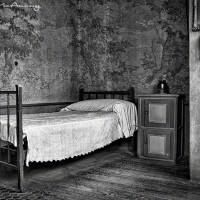 black and white photo of vintage single bed